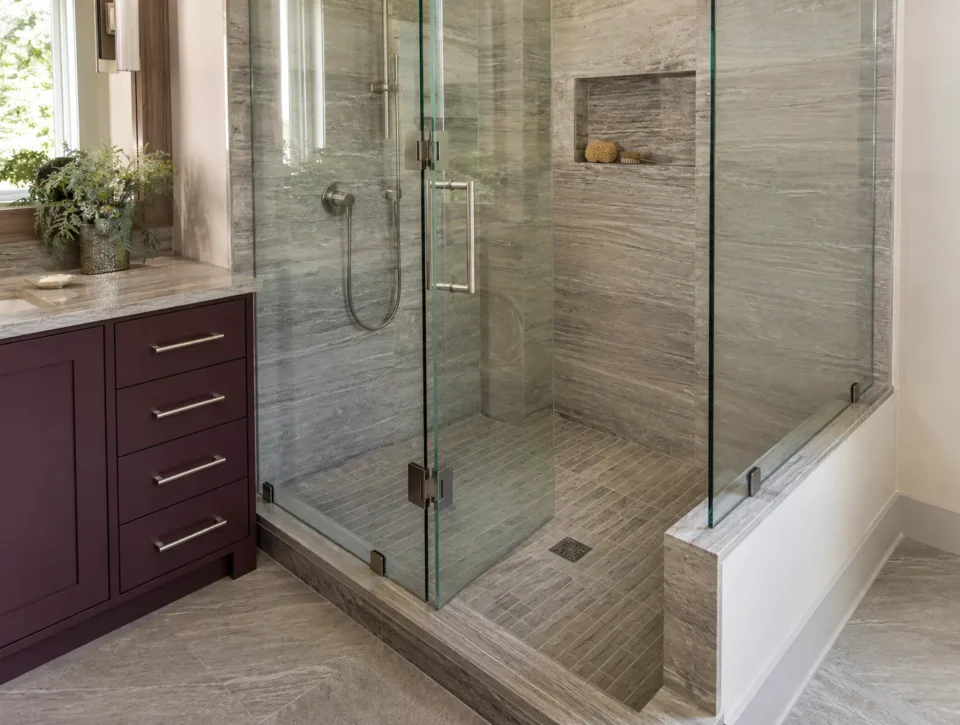 Frameless shower enclosure showing pivot door, fixed panel, hardware and vanity clearance
