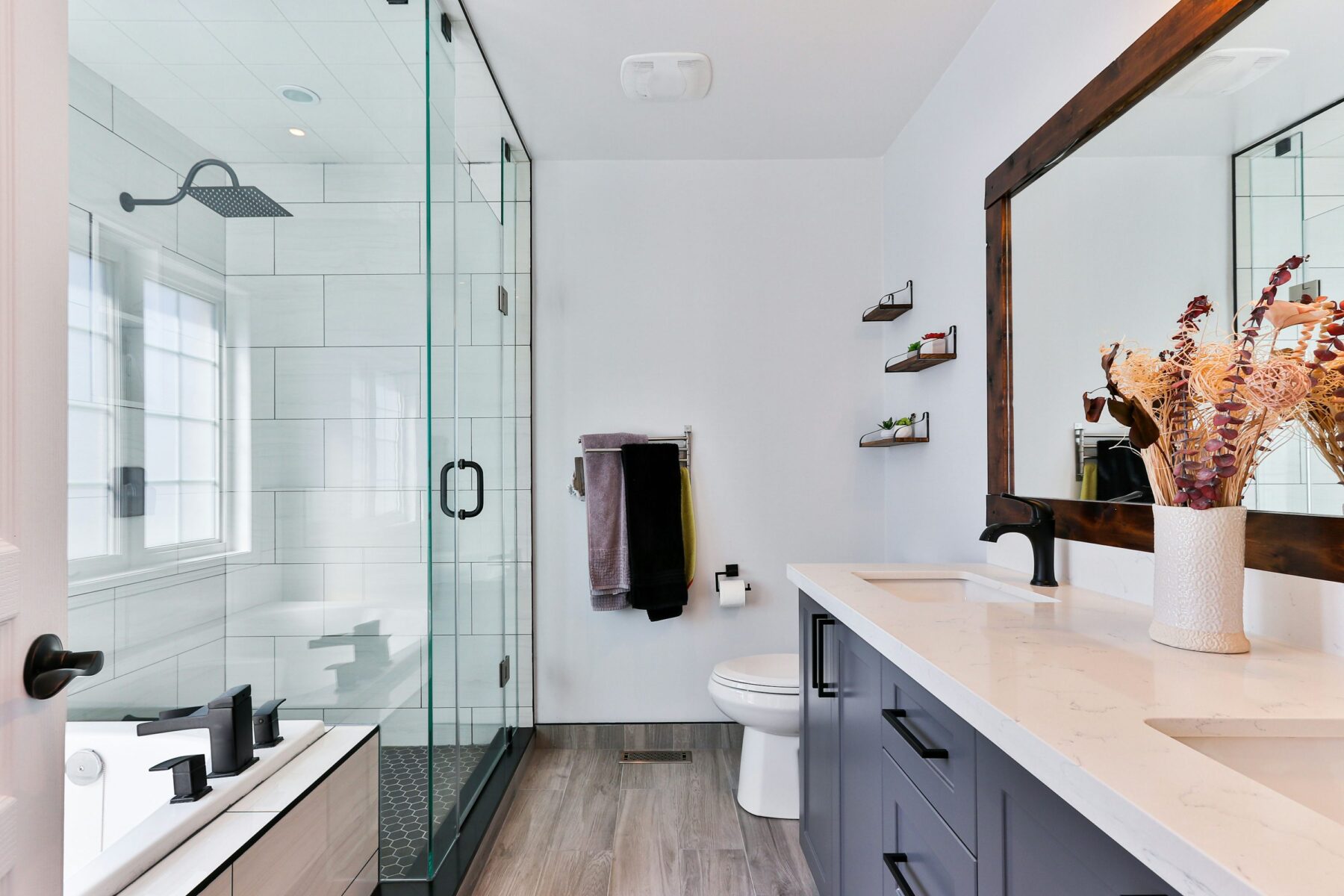 Contemporary bathroom with glass shower, dark vanity and black fixtures