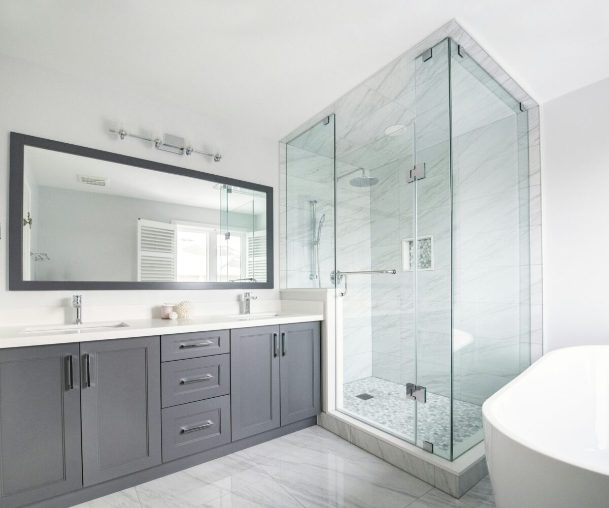 Bright ensuite with double vanity, glass shower and freestanding bathtub