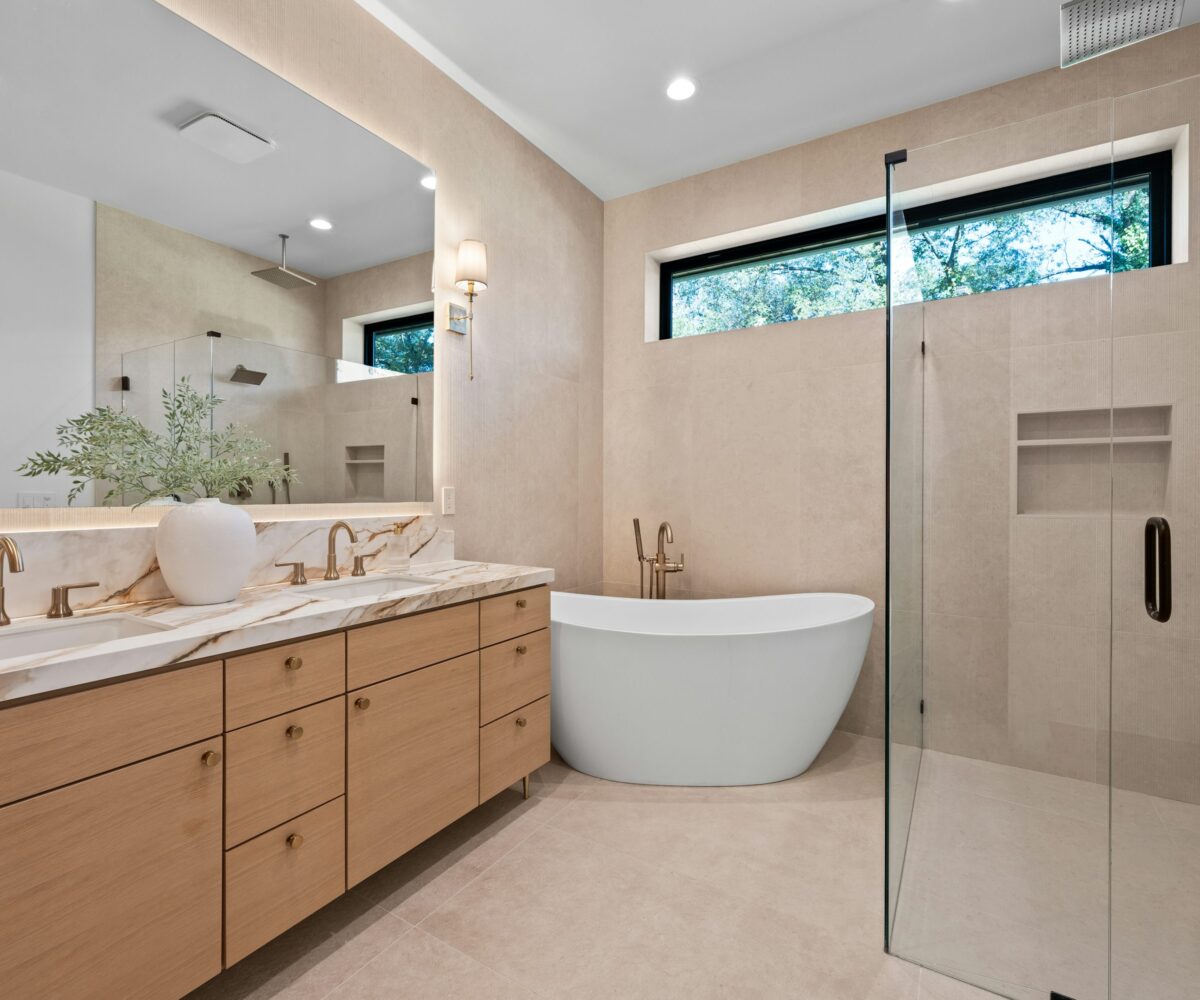 Warm contemporary bathroom with oak double vanity, freestanding tub and frameless walk-in shower