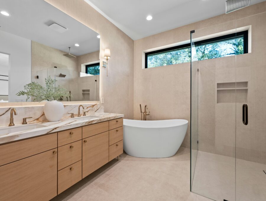 Warm contemporary bathroom with oak double vanity, freestanding tub and frameless walk-in shower
